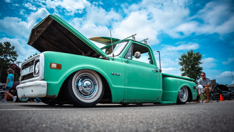 Mint-green lowered pickup truck with its hood open at the Warner Robins Fire Department Auto Show.