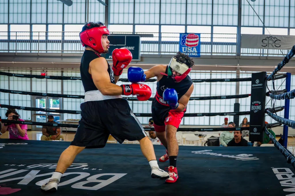 Ivan Pascacio-Gomez lands a punch on Francisco Luna in a boxing ring