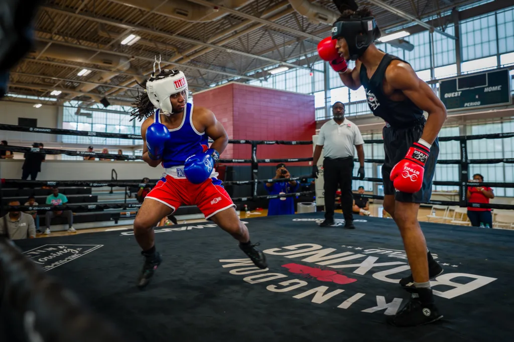 Pierre Grant and Andre Lowe trading punches in an indoor boxing ring