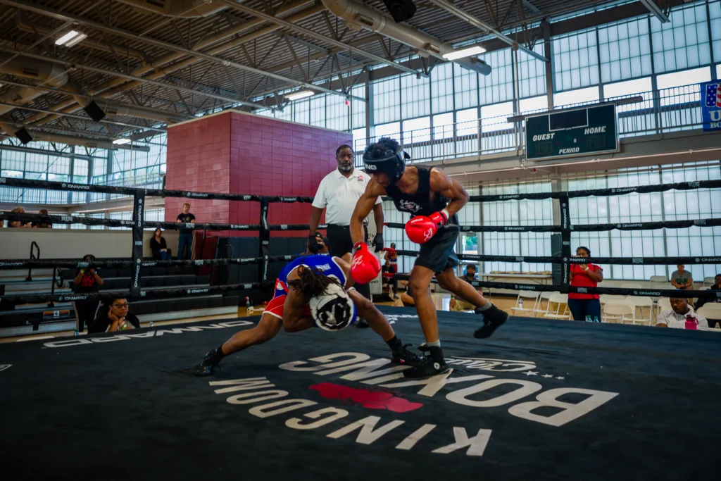 Pierre Grant dodges as Andre Lowe throws a punch in a boxing ring