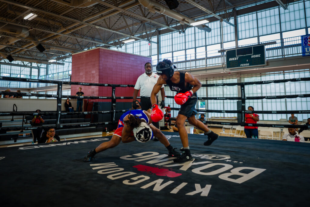 Pierre Grant dodges as Andre Lowe throws a punch in a boxing ring