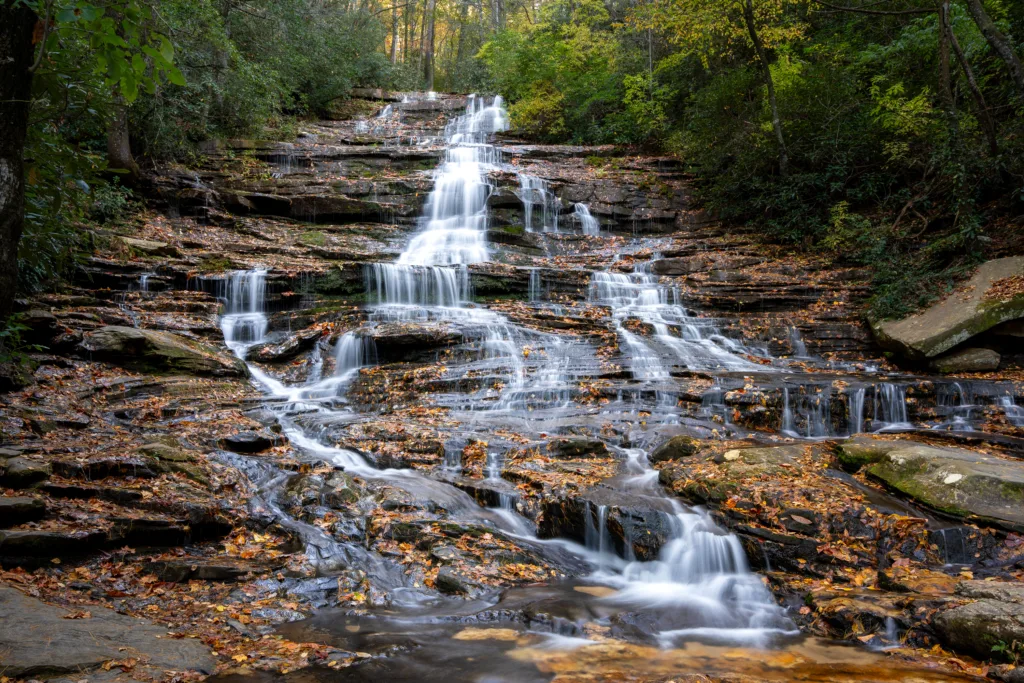 Tiered Minnehaha Falls in North Georgia flowing over rock ledges in autumn