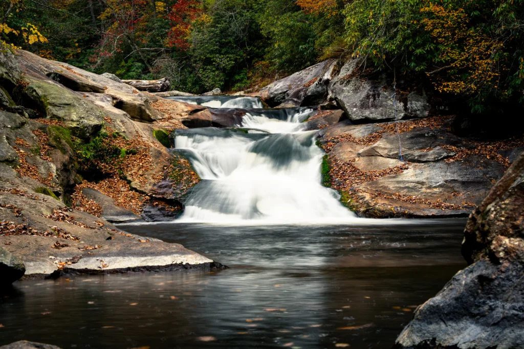 Quarry Falls waterfall cascading over smooth rock ledges in autumn