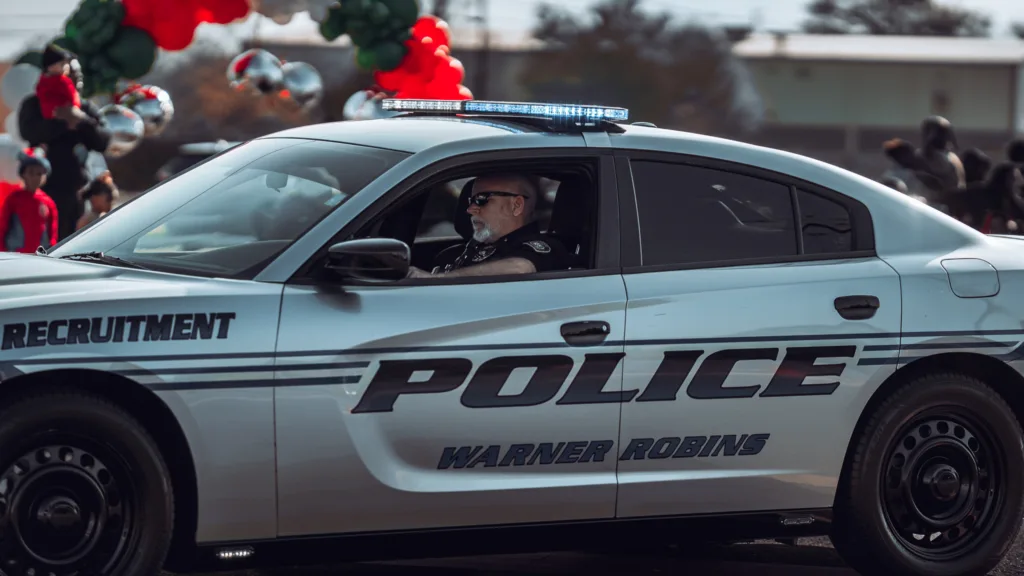Warner Robins police recruitment car driving in a community parade