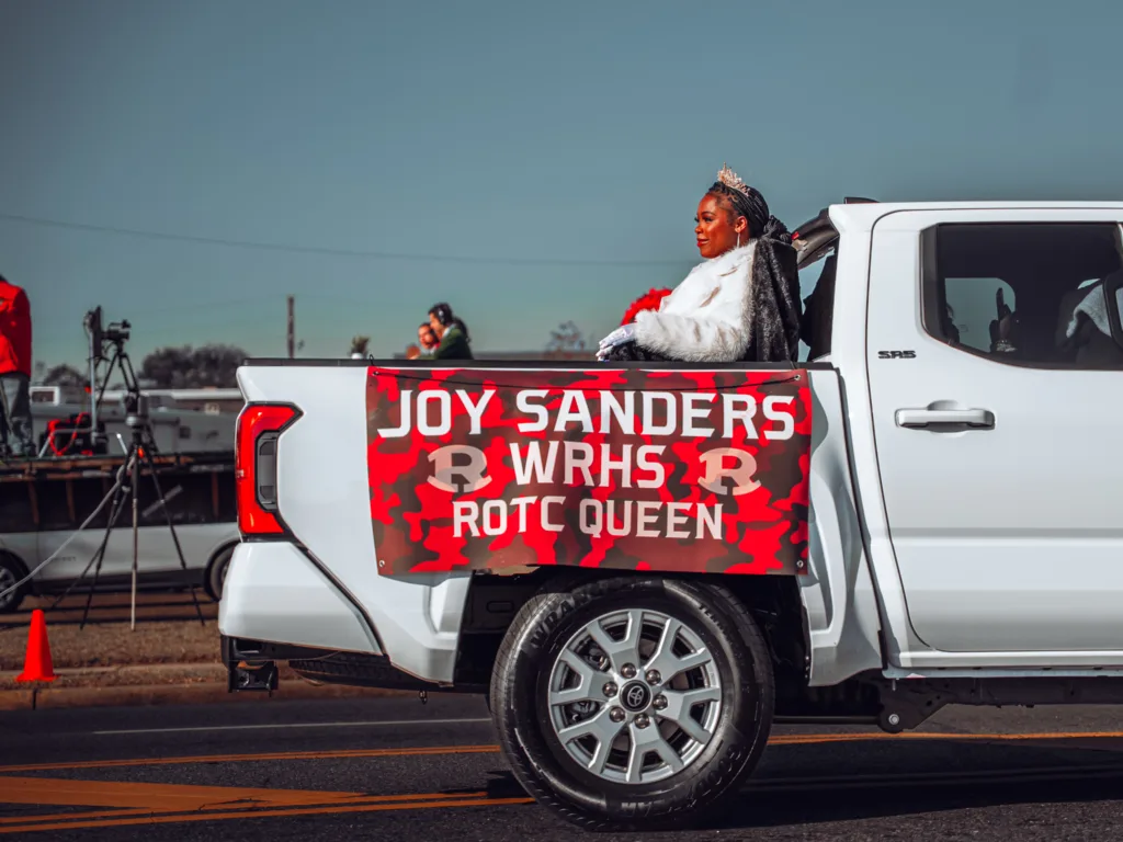 Joy Sanders WRHS ROTC Queen riding in white pickup truck during parade