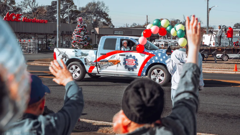 Decorated pickup truck with balloons driving in a holiday parade