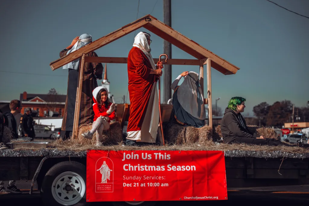 Parade float featuring a live nativity scene with people in biblical costumes