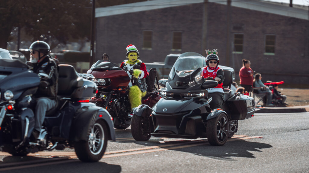 Riders on decorated trikes and motorcycles in a holiday parade