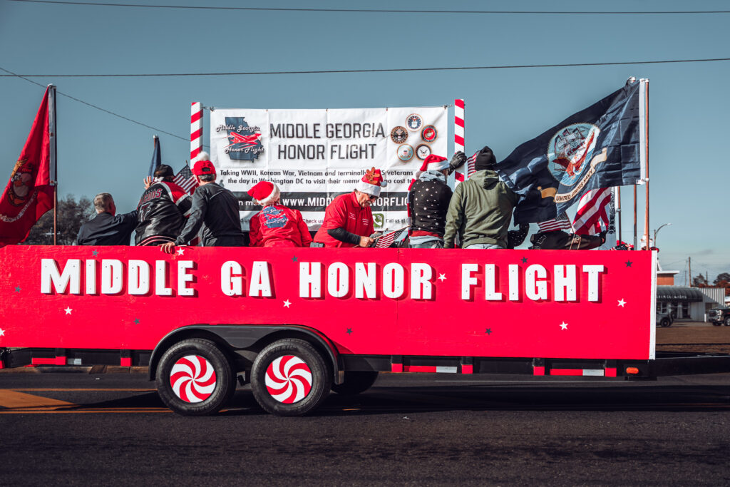 Middle Georgia Honor Flight parade float with people and flags