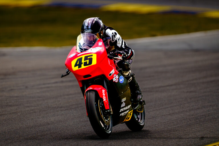 Rider leans a red number 45 motorcycle into a turn at Road Atlanta.
